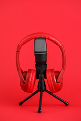 Microphone and headphones on red background