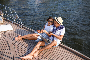 Poster - Happy young couple resting on yacht