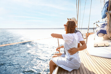 Wall Mural - Happy young couple resting on yacht