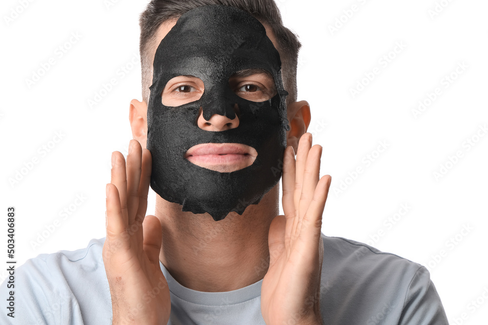 Handsome man with black facial mask on white background, closeup