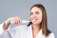Young Woman Brushing Teeth. Beautiful Smile Of Young Woman With Healthy White Teeth. Isolated Background. Dental Care. White Tooth.