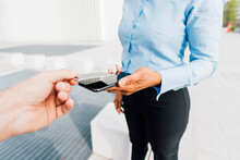 Hand Of Man Holding Credit Card Using Tap To Pay Method With Freelancer