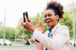 © Westend61 - Happy businesswoman on video call waving at smart phone