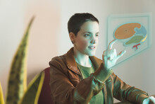 Freelancer With Short Hair Analyzing Human Brain Hologram Design On Transparent Screen