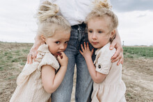 Blond Girls Standing With Mother In Agricultural Field