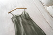 © Westend61 - Green nightgown on bed at home