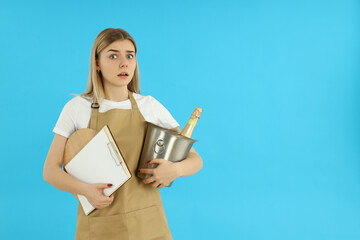 Wall Mural - Concept of occupation, young waiter on blue background