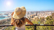 woman tourist looking at Malaga city panoramic view