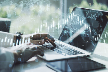 Multi exposure of abstract creative financial chart with world map and with hand typing on computer keyboard on background, research and analytics concept