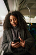 © Johnér - Woman in bus using cell phone