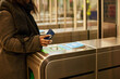 © Johnér - Woman paying for subway ticket with smart phone
