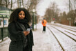 © Johnér - Woman at train station platform using cell phone