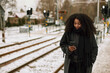 © Johnér - Woman at train station platform using cell phone