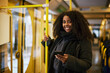 © Johnér - Woman in bus holding cell phone