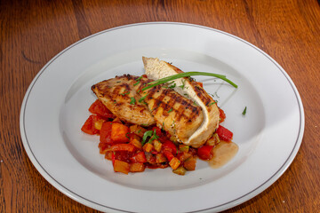 Wall Mural - Grilled chicken meat and fresh vegetable salad of tomato, avocado, lettuce and spinach. Healthy and detox food concept. Ketogenic diet.