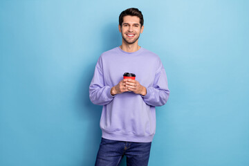 Sticker - Photo of nice millennial brunet guy hold cappucino wear pullover isolated on blue color background