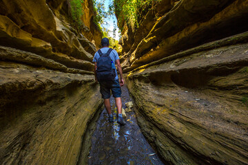 A tourist man in the beautiful canyon of Hell's Gate Park in Naivasha, Kenya