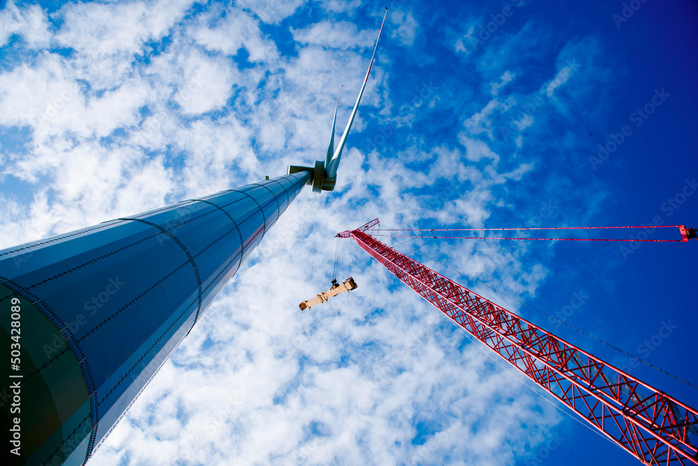 Construction of Wind Turbine Tower using Big red crane under beautiful ...