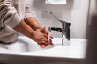 © Johnér - Mid section of woman washing hands