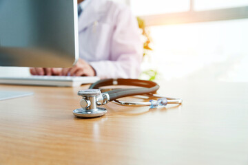 Doctor at work with a stethoscope on desk