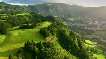 aerial shot of green meadows and hills of azores. classical green landscape at sunset of san miguel 