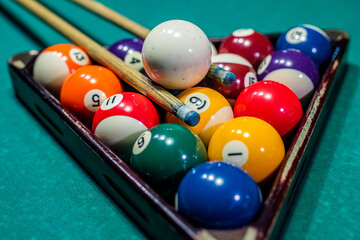 beautiful game of colored layers on a green table with holes and table lamps.