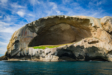 Skull Rock stone island seascape in Cruising tour view in the Bass Strait at Wilson Promontory Victoria Australia, blue sky and blue sea