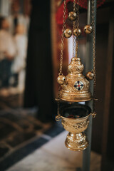 Sticker - Closeup of a censer hanging in a church