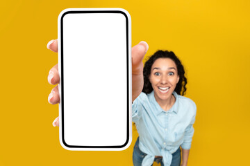 Woman showing white empty smartphone screen close to camera