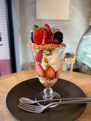 Sticker - Closeup shot of a  glass of tasty parfait dessert with ice cream and fruits