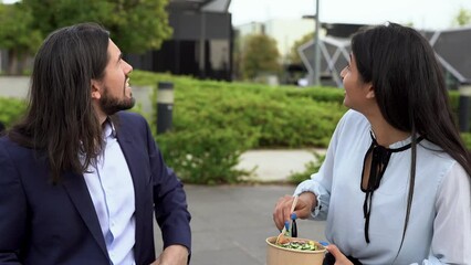 Wall Mural - Young business people eating healthy poke food in the city 