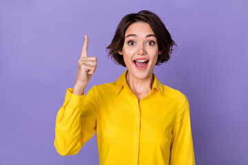 Sticker - Photo of impressed millennial lady index up wear yellow shirt isolated on purple color background