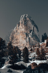 Wall Mural - Winter mountain landscape. Torre Grande - Cima Ovest, Cortina d'Ampezzo, Italy. Yellow-gray rock against the gray sky. Vertical image.