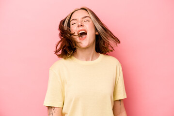 Wall Mural - Young caucasian woman isolated on pink background dancing and having fun.