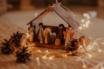 Poster - Selective focus shot of a nativity scene surrounded by Christmas lights