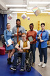 © Seventyfour - Vibrant full length portrait of diverse group of students young man with disability in foreground all looking at camera