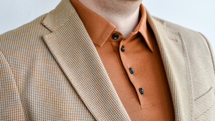 Wall Mural - Detail of summer outwear, light beige blazer combined with brown polo. Selective focus.