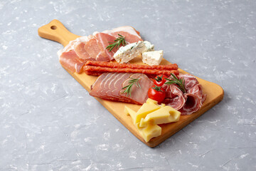 Wall Mural - Appetizers table with different antipasti, charcuterie, snacks and cheese. Buffet party. Top view, copy space, negative space. Grey background