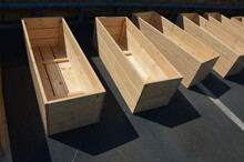 Funeral Services Have Many Contracts. Production Of Cheap Coffins Or Wooden Flower Pots For The Terrace Feeds Carpenters. Row Of Empty Wooden Rectangular Flower Boxes