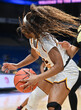 © Joe - Girl with long hair dribbling the ball in a basketball game