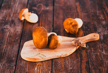Boletus Edulis Over Wooden Background. Autumn Cep Mushrooms. Cooking Delicious Organic Mushroom. Gourmet Food