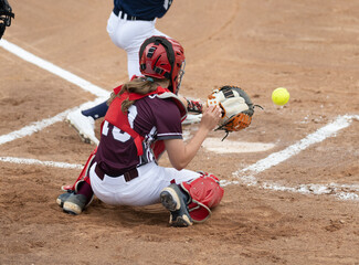 Wall Mural - Athletic girls in action playing in a softball game