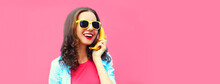 Colorful Portrait Of Funny Young Woman Calling On Banana Phone Looking Away On Pink Background, Blank Copy Space For Advertising Text