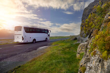 White Bus Passing Mountain. Beautiful Cloudy Sky In The Background. Tourism Industry. West Of Ireland.