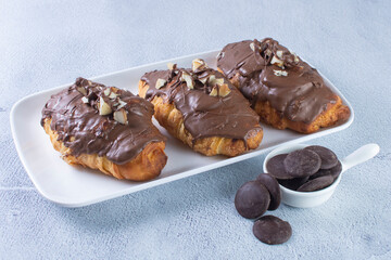 Sticker - Chocolate croissant with walnut pieces, displayed on gray background