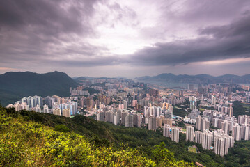 Sticker - View of the Kowloon walled city from Lion Rock hill under a stormy cloudy sky in Hong Kong, China