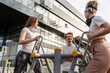 © Miljan Živković - Group of friends man and women male and young adult people training at outdoor open gym in park in front of modern building real people sport and recreation exercise healthy lifestyle concept