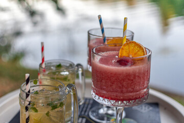 Canvas Print - Strawberry daiquiri and mojito cocktails in the blurred background