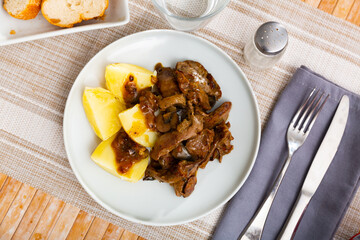 Braised rabbit liver with garnish of boiled potato, homemade dinner