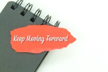 Black Notebooks And Torn Paper With The Words Keep Moving Forward